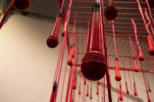 red microphones coming from the ceiling
